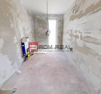 An unfinished room in a family house with visible installations and wires.