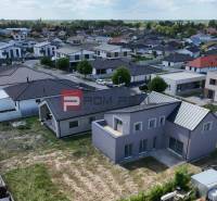 A view of a family house in Cífer surrounded by a residential urban area.
