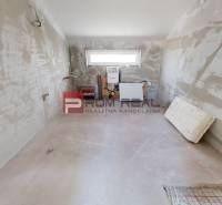 Unfinished interior in a family house with a window and connection equipment.