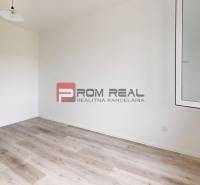Empty room with white walls, laminate flooring, and a window in a 2-room apartment.