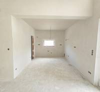 Interior of a family house with unfinished walls and floor, ready for completion.
