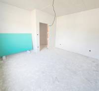 Empty room in a family house with white walls and a green board.