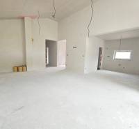 The interior of a family house with unfinished walls and a window, ready for completion.