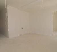 A bright room in a holiday apartment with white walls and ongoing installation.