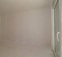 Empty room with white walls and a French window in a holiday apartment.