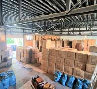 Warehouses and halls full of boxes and bags indoors.