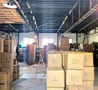 Warehouses and halls full of boxes and goods with metal ceiling beams.