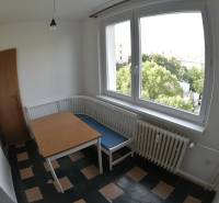 Dining room with a corner bench and a view in a 2-room apartment.
