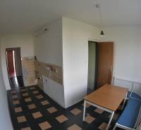 Dining room in a 2-room apartment with a dining table and a bench by the window.