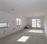 A room under construction in a family house with prepared installations and a concrete floor.