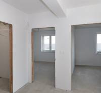 Interior of a family house with unfinished rooms and white walls.