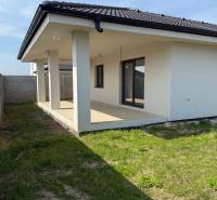 A family house in Galanta Košúty with a veranda and a grassy yard.