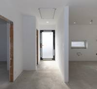 Empty hallway in a family house with white walls and open space.