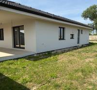 A family house in Galanta Košúty, with a white facade and a sloped roof on a grassy area.