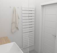 A bathroom with a white radiator, a sink, and a wooden countertop in a 2-room apartment.
