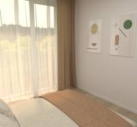 A bedroom in a two-room apartment with a bed, paintings, and curtains by the window.