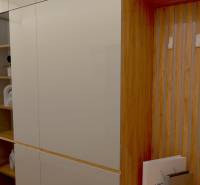 Built-in wardrobe and wooden hangers in the hallway of a 2-room apartment, view into the living room.