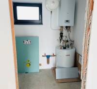 Technical room in a family house with a boiler and a water tank.