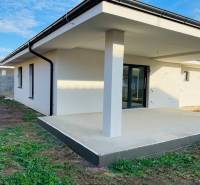 A family house in Kynek near Nitra with a terrace, lawn, and fence on a spacious plot.
