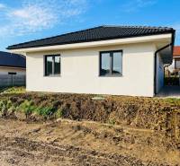 A family house in Kynek in Nitra, next to it earthworks and an electrical distributor.