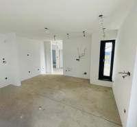 Empty room with a window and white walls in a family house.