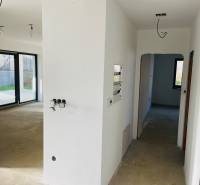 White corridor, electrical installation, large windows, view inside the family house.