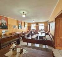 Rustic gastro spaces with wooden furnishings and decorations on the walls.