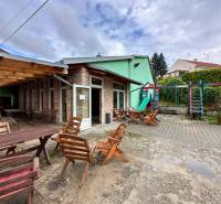 In Moravany nad Váhom, there are outdoor gastro areas with wooden seating and a playground.