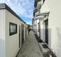 Narrow exterior passage between buildings on Padlých hrdinov, Bratislava - Podunajské Biskupice.