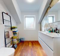A bathroom in a 5 or more room apartment with a sink, toilet, and shelves for towels.