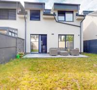 A two-story apartment with 5 or more rooms, a terrace, and a grassy area.