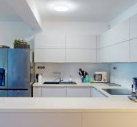 A kitchen with a refrigerator, sink, and appliances in a 5 or more room apartment.