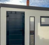 A door and a window on the exterior wall of a building on Padlých hrdinov Street.