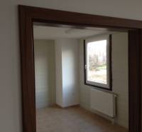 Room with a door frame, window, and radiator in storage and warehouse spaces.