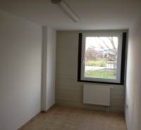 A room with a light floor, tiles, and a radiator, suitable for storage and halls.