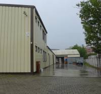 The exterior of warehouses and halls in Bratislava - Rača during a rainy day.