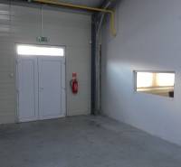 Interior of warehouses and halls with white doors and a fire extinguisher.