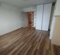 A spacious room with wooden flooring and a built-in wardrobe in a 3-room apartment.