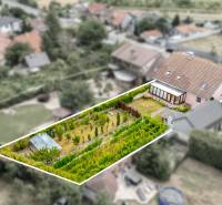 A picture of a family house in Vinosady with a large plot of land and a well-maintained garden.