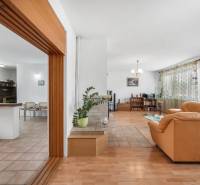 Interior of a family house with a bright living room, comfortable sofa, and dining area.