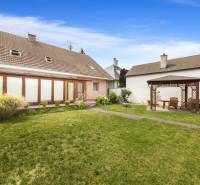The garden of a family house in Vinosady with a wooden gazebo and a lawn.