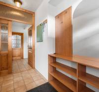 A hallway with built-in wooden furniture in a family house.