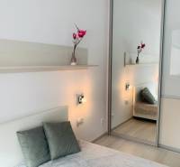 A bright bedroom on Palisády Street with large mirrors in a 2-room apartment.