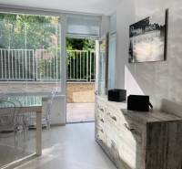 Bright living room in a 2-room apartment on Palisády Street with a view of the terrace.