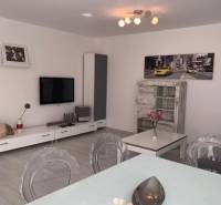 Living room in a 2-room apartment on Palisády Street with modern furniture and a painting.