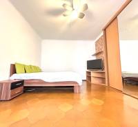 A bedroom in a 3-room apartment with a mirrored wardrobe and a television, reminiscent of a cozy home.