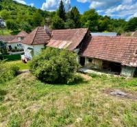 A family house in Horná Súča surrounded by greenery with a traditional red tile roof.