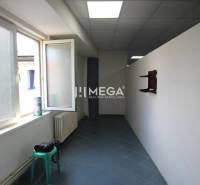 A narrow space with a window and a chair, ideal for commercial premises.