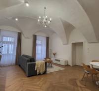Stylish 1-bedroom apartment with vaulted ceiling, wooden floor, and a sofa.