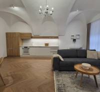 2-bedroom apartment with vaulted ceilings, a modern kitchen, and a comfortable living room with a chandelier.